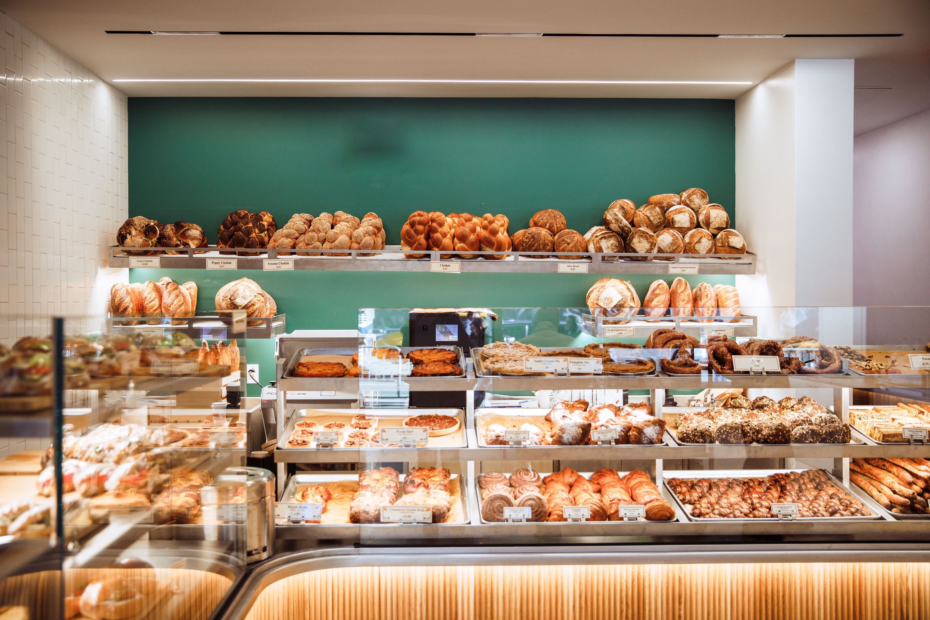Bakery shelves filled with artisan loaves, pastries, and freshly prepared treats