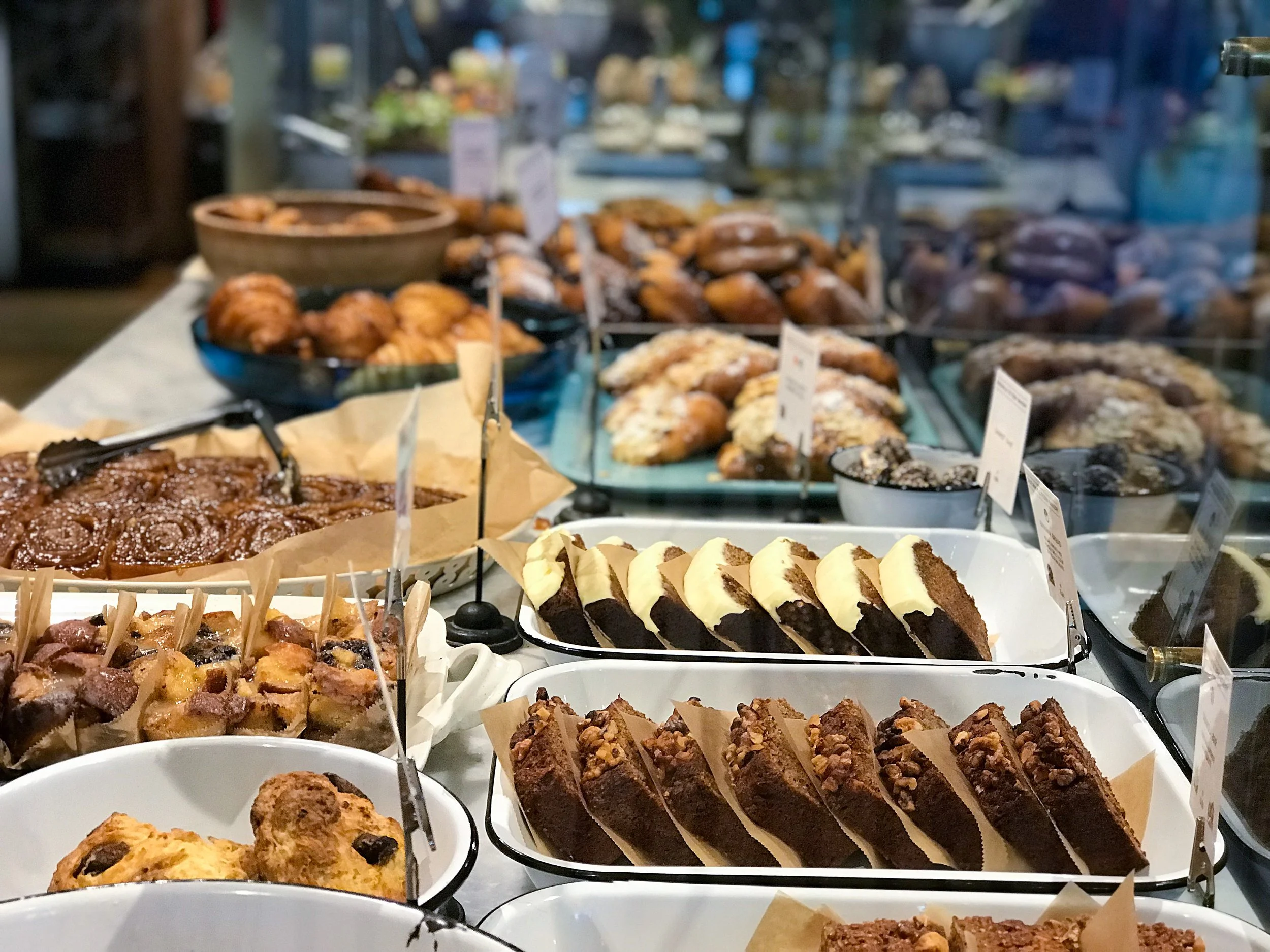 Freshly baked artisan bread and golden pastries arranged on a bakery table